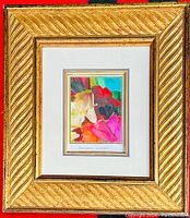 Full view of the framed original painting showing the abstract floral composition and the gold-tone frame under glass.