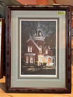 Full view of framed lithograph print showing Victorian house and horse carriage at night.