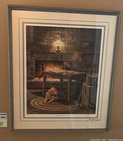 Full framed limited edition print showing a man sitting at a table by a fireplace with a dog on a round braided rug.
