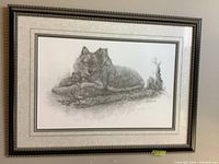 Framed limited edition print showing the full artwork of a wolf lying on a log. The frame is black with beaded detailing and beige matting.