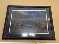 Full frontal photo of the framed limited edition print showing the northern lights and mountain landscape.
