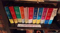 Bookshelf view of The Story of Civilization hardcover book set by Will Durant, showing colorful dust jackets and titles