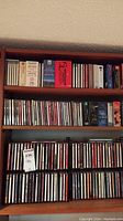 Wide shot of shelves containing multiple rows of CDs including classical and jazz collections with various jewel cases.
