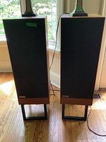 Front view of both Tangent RS6 speakers on stands in front of window
