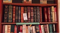 Overall view of top shelf showing multiple Franklin Library leather-bound books in various colors.