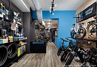Interior of Epic Cycles store showing bicycles, folding bikes, tires, and service counter area.