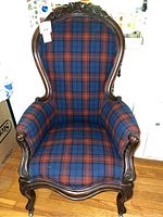 Full view of antique armchair showing dark wood frame with curved arms and legs, upholstered in blue and rust red Scottish wool tartan plaid fabric.