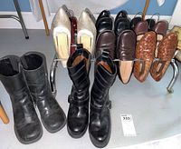 Full view of 7 pairs of women's shoes and boots arranged on a rack showing variety of styles and colors.