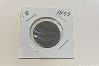Front side of the 1895 Canadian one cent coin in white cardboard holder, labeled 1¢ and 1895.