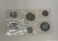 Six Canadian coins sealed in plastic blister packaging, displayed on white surface.