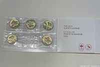 Photo showing the full set of five sealed 2016 Lucky Loonie coins in clear plastic with the accompanying card from the Royal Canadian Mint.