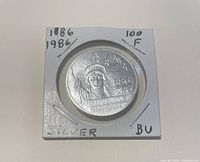 Front of the France 1886-1986 100 Franc silver coin showing the crowned figure and dates 1886 1986 with 'REPUBLIQUE FRANÇAISE' text