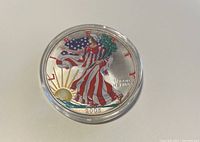 Obverse side of coin showing the colored Walking Liberty design with sun rising, year 2005, and inscriptions.