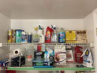 Two shelves filled with multiple household cleaning products including sprays, liquids, and boxed wet cloths.