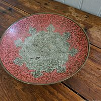 Full top view of the brass bowl showing the pink enamel and intricate floral and ornamental patterns