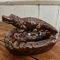 Close-up showing the alligator detail and the FLORIDA inscription on the ashtray.