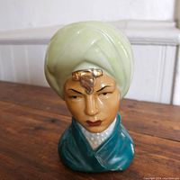 Front view of the mid-century ceramic head planter showing its detailed glazing and design.