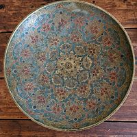 Top-down view showing full floral enamel pattern inside the large brass bowl.