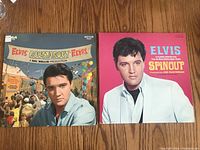 Front covers of two Elvis Presley soundtrack LP vinyl records - Roustabout and Spinout.