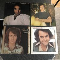 Front covers of four Neil Diamond LP records showing portraits and titles September Morn, Heartlight, Moods, Primitive