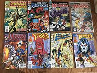 Photo showing all 8 Marvel comic books arranged in two rows on a flat surface, displaying front covers with colorful artwork and characters.