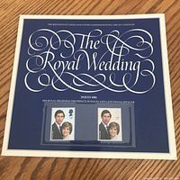 Full view of the souvenir card with the title and two attached stamps in clear sleeves.