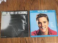 Two Elvis Presley LP vinyl record covers laid flat, showing front covers. 'Elvis: The First Live Recordings' in black and white and 'For LP Fans Only' in color with a smiling young Elvis.