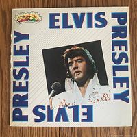 Front cover of Elvis Presley vinyl LP record with singer's photo and name in blue letters