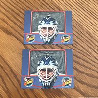 Front view of two identical Felix Potvin flip-up cards showing goalie mask and Team Tiger logos