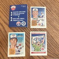 Front side of collector cards including Claude Raymond, Barry Bonnell, and Famous Moments cards alongside original packaging