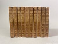 Front view of the 10 antique book collection volumes showing titles and ornate spine details.