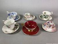 View of all five teacup and saucer sets showing various floral patterns and designs