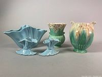 Front view of all four ceramic pieces including blue Beswick planter and posy vases, and Crown Devon vase