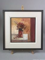 Full view of the framed oil painting depicting the red vase with flowers on a textured surface.