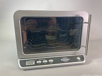 Full view of the wine cooler showing the transparent door, metal handle, wire racks inside for 6 bottles, and digital control panel below the door.