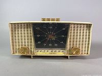 Front view of the Electrohome Roland Series clock radio with visible clockface, knobs, and tuning scale.