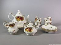 Full set view showing platter, teapot, creamer, sugar bowl, cups and saucers