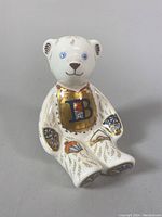 Front view of the Royal Crown Derby Alphabet Bear figurine showing detailed gold decoration, blue eyes, and letter 'B' shield on chest.