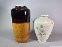 Two vases side by side: KPM Krister white floral porcelain vase approx. 12 inches tall and Scheurich #517-38 West Germany pottery vase, 8x15 inches, brown and yellow color.