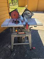 Front view of table saw on stand with two blades installed