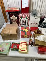Front view of all items spread on a white sheet showing boxes, a figurine, string lights, and more.