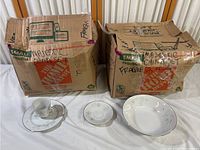Two cardboard boxes labeled Majestic China collection, each approximately 16 x 12 x 12 inches, with visible porcelain dinnerware items packed inside.