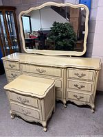 Front view of the cream-colored Mid-Century Modern dresser with large mirror and matching nightstand showing overall style and condition.
