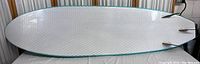 Top side view of the white textured crisscross pattern foam top surfboard showing streamlined shortboard shape