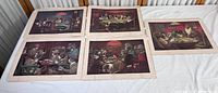 Overview of all five vintage Dogs Playing Poker prints laid out on table.