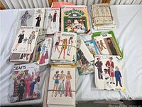 Overview photo of vintage sewing pattern collection including Butterick, Simplicity, McCall's, Cabbage Patch Kids, and craft pattern magazines