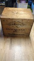 Front view of wooden crate with black stencil text 'W.H.M.&Co. LTD. Vancouver B.C. Via Hong Kong'