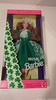 Front view of Irish Barbie doll in original box with green dress and shamrock decorations.