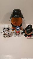 Front view of all four Mr Potato Head Star Wars figures and Darth Vader head container