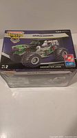 Front view of sealed box showing Gravedigger truck illustration, scale 1:25, AMT and Monster Jam branding.